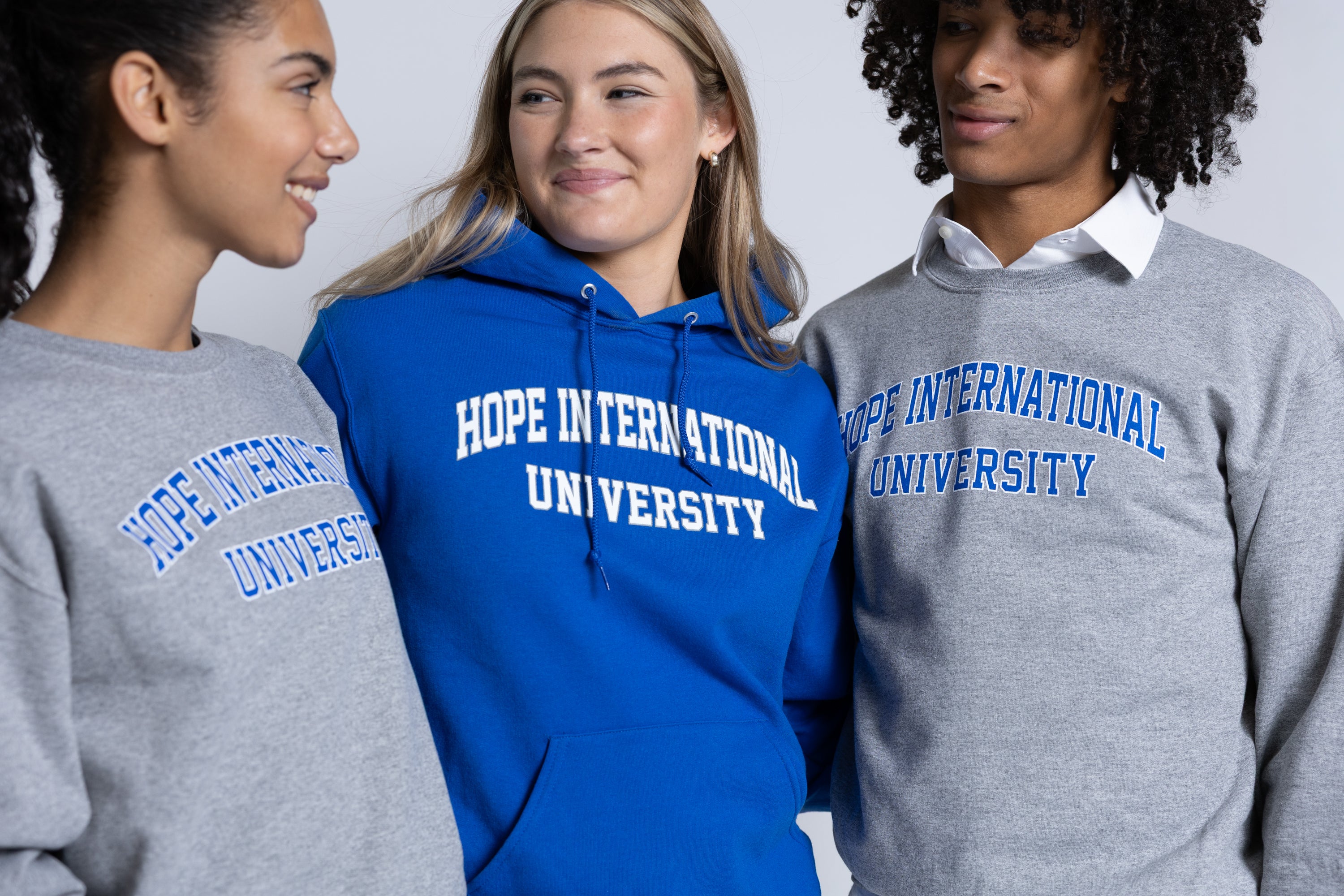 3 People wearing Hope International University sweatshirts 